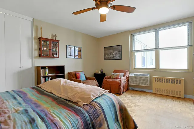 a bedroom with two beds and a window