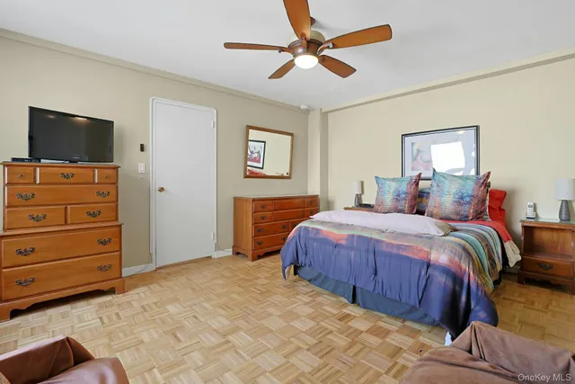 a bedroom with a bed and a television