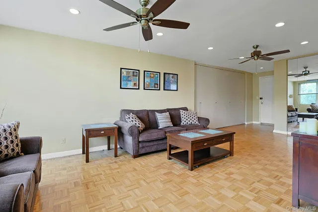 a living room with furniture and a ceiling fan