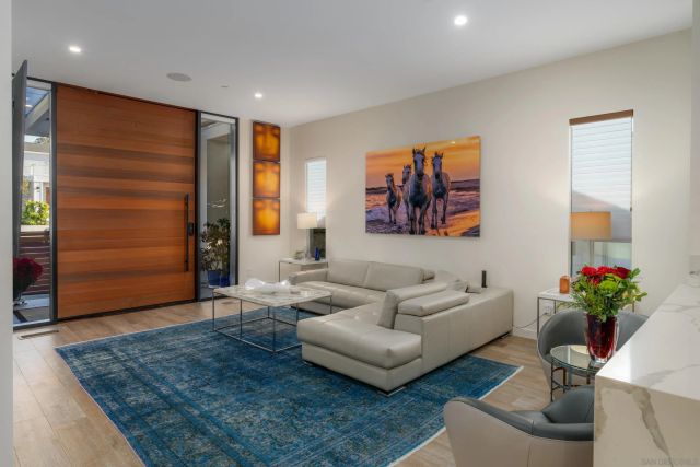 a living room with furniture and flowers