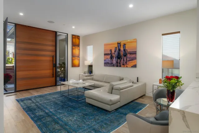 a living room with furniture and flowers