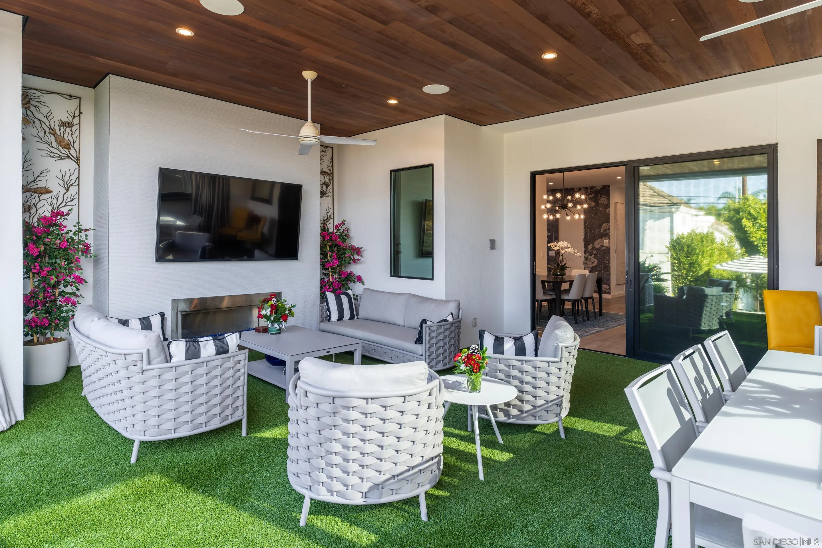 1224 Virginia Way La Jolla, CA 92037 - Photo 12 of 45 a living room with furniture a flat screen tv and a large window