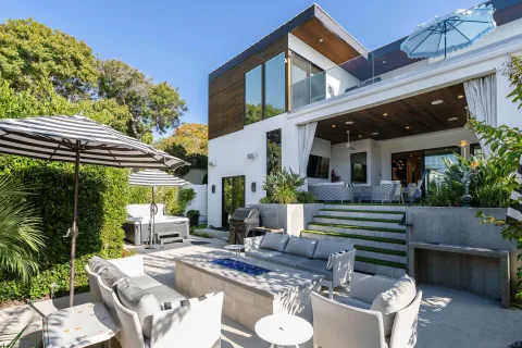 a view of house with backyard outdoor seating and plants