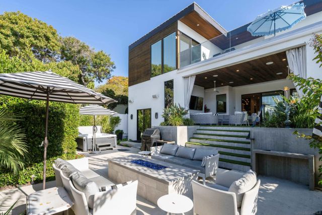 a view of house with backyard outdoor seating and plants