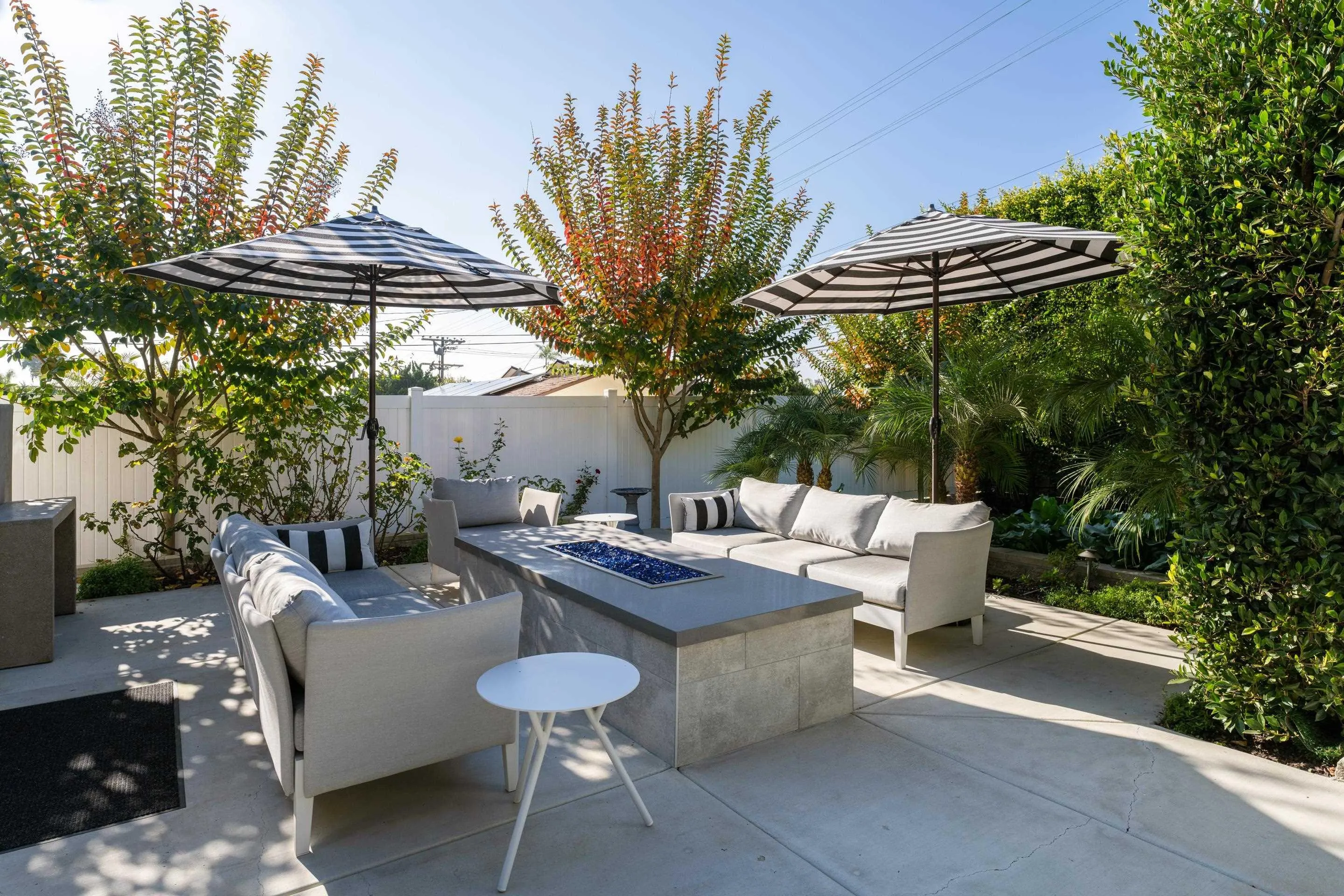 1224 Virginia Way La Jolla, CA 92037 - Photo 26 of 45 a view of a patio with couches table and chairs and potted plants