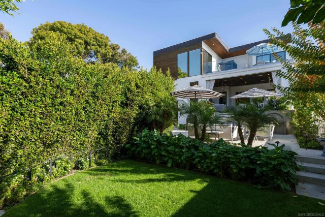 a view of a house with a yard and plants