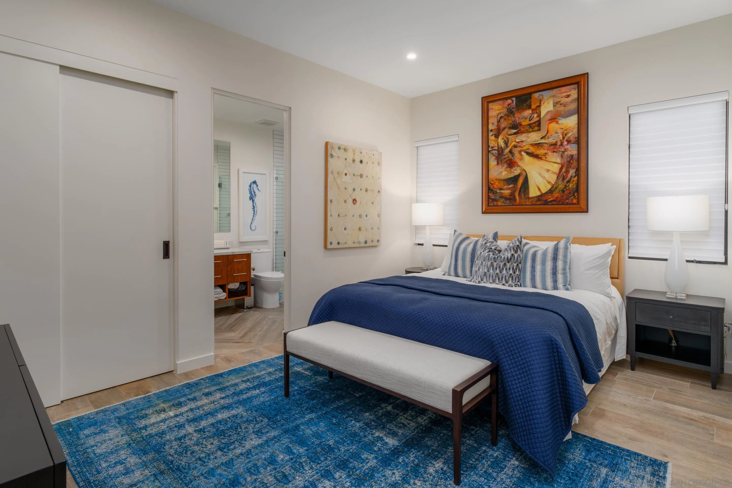 1224 Virginia Way La Jolla, CA 92037 - Photo 36 of 45 a spacious bedroom with a bed and wooden floor