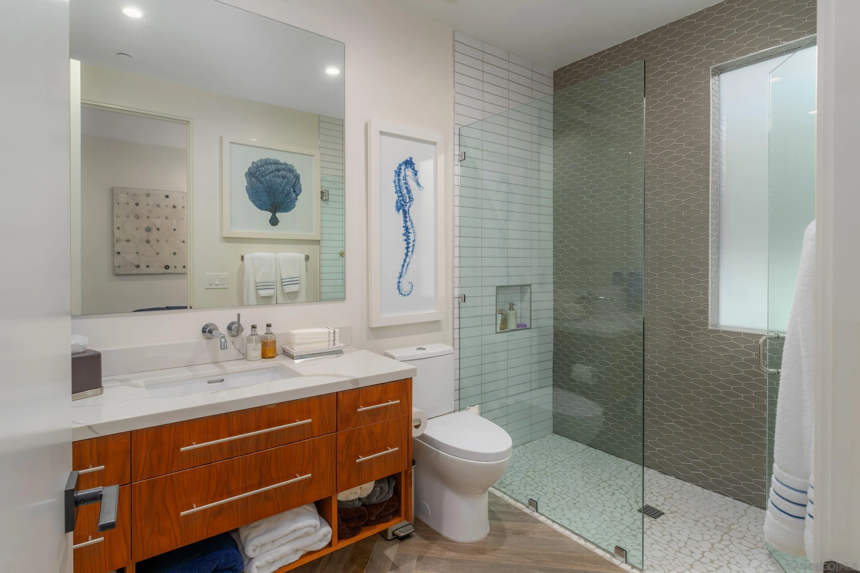 1224 Virginia Way La Jolla, CA 92037 - Photo 39 of 45 a bathroom with a toilet sink and mirror