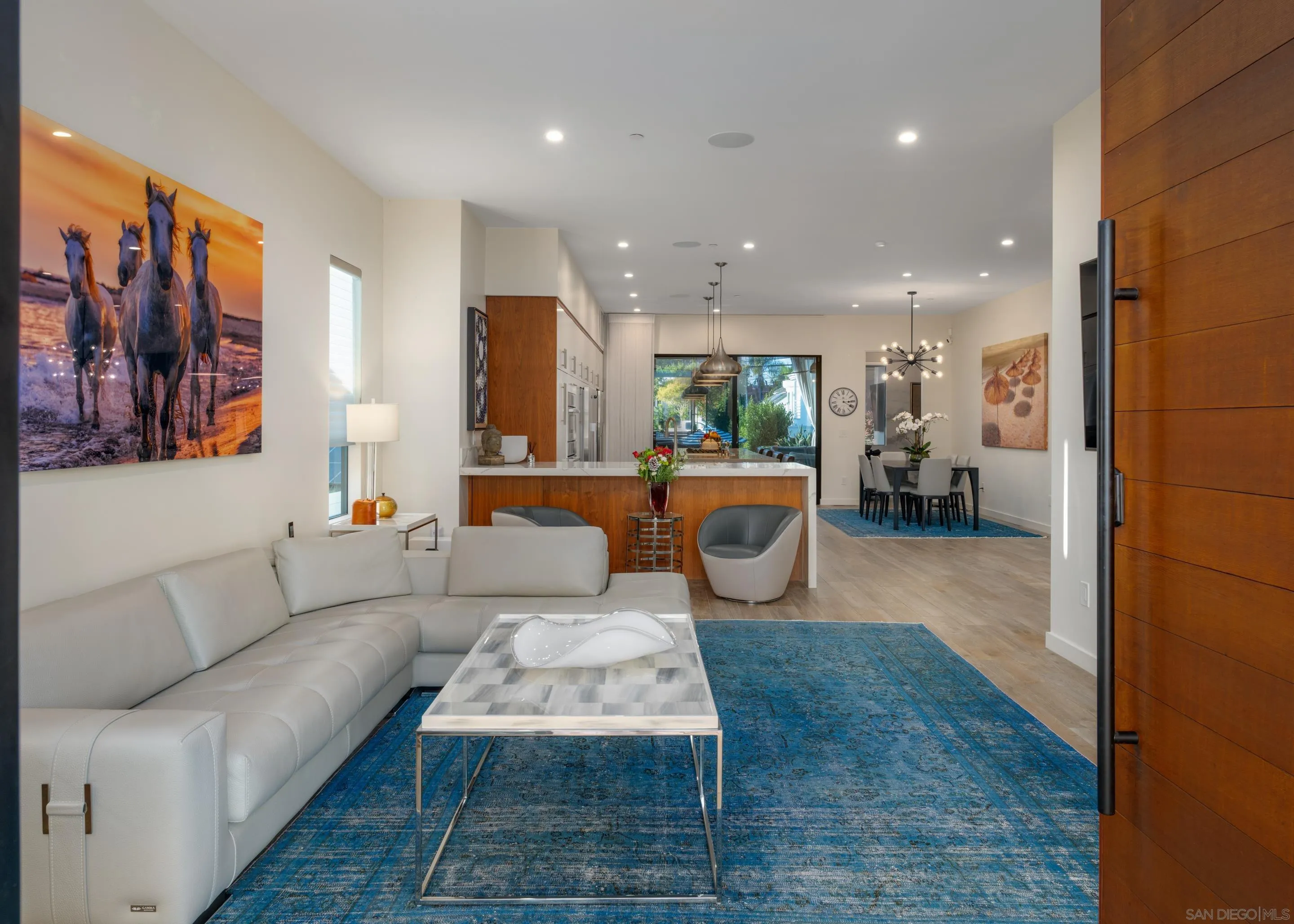 1224 Virginia Way La Jolla, CA 92037 - Photo 4 of 45 a living room with furniture a rug and kitchen view