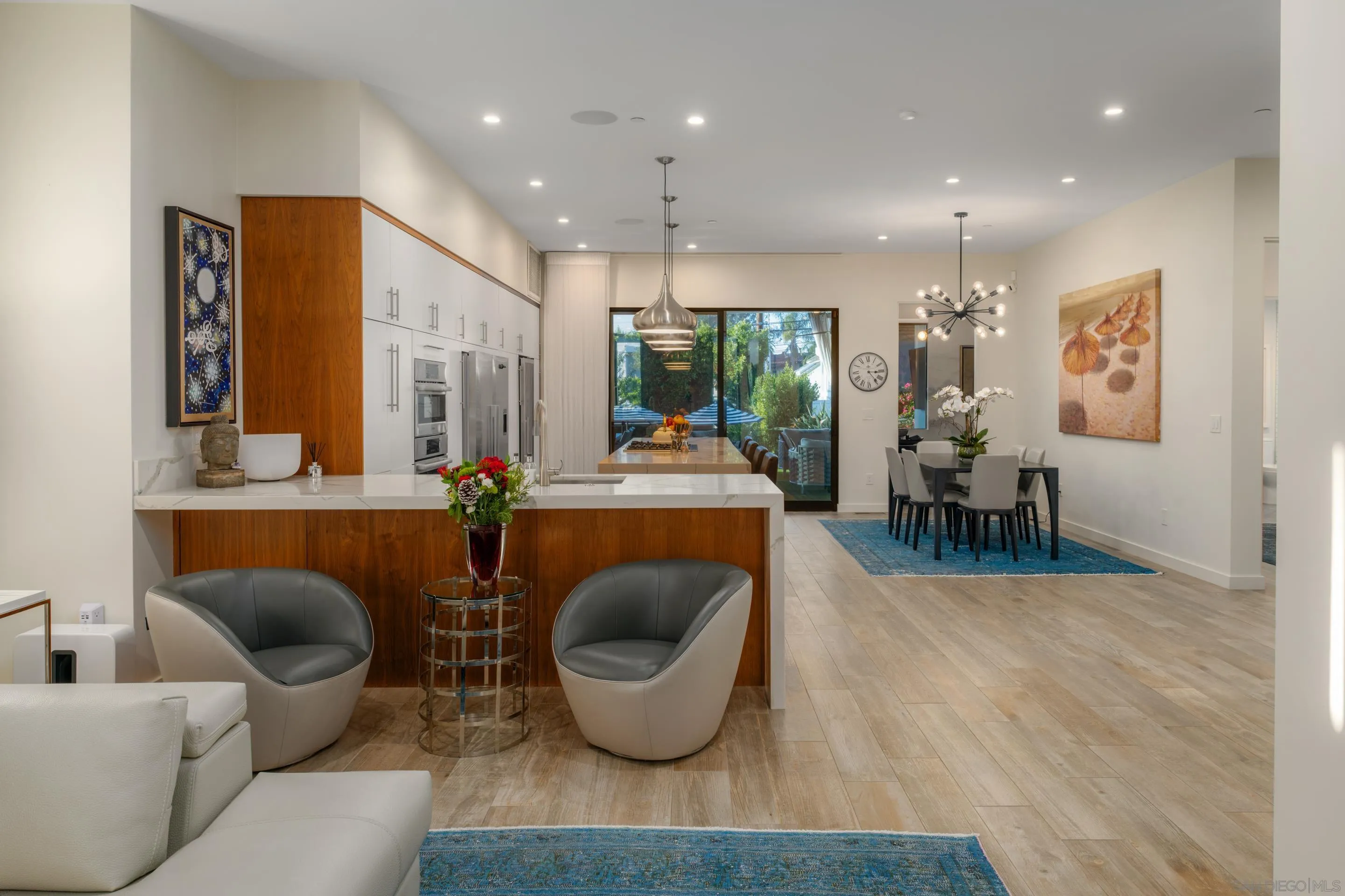 1224 Virginia Way La Jolla, CA 92037 - Photo 5 of 45 a living room with furniture a rug and a chandelier