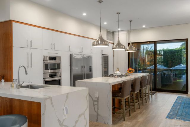 a kitchen with kitchen island a large counter top space appliances and cabinets