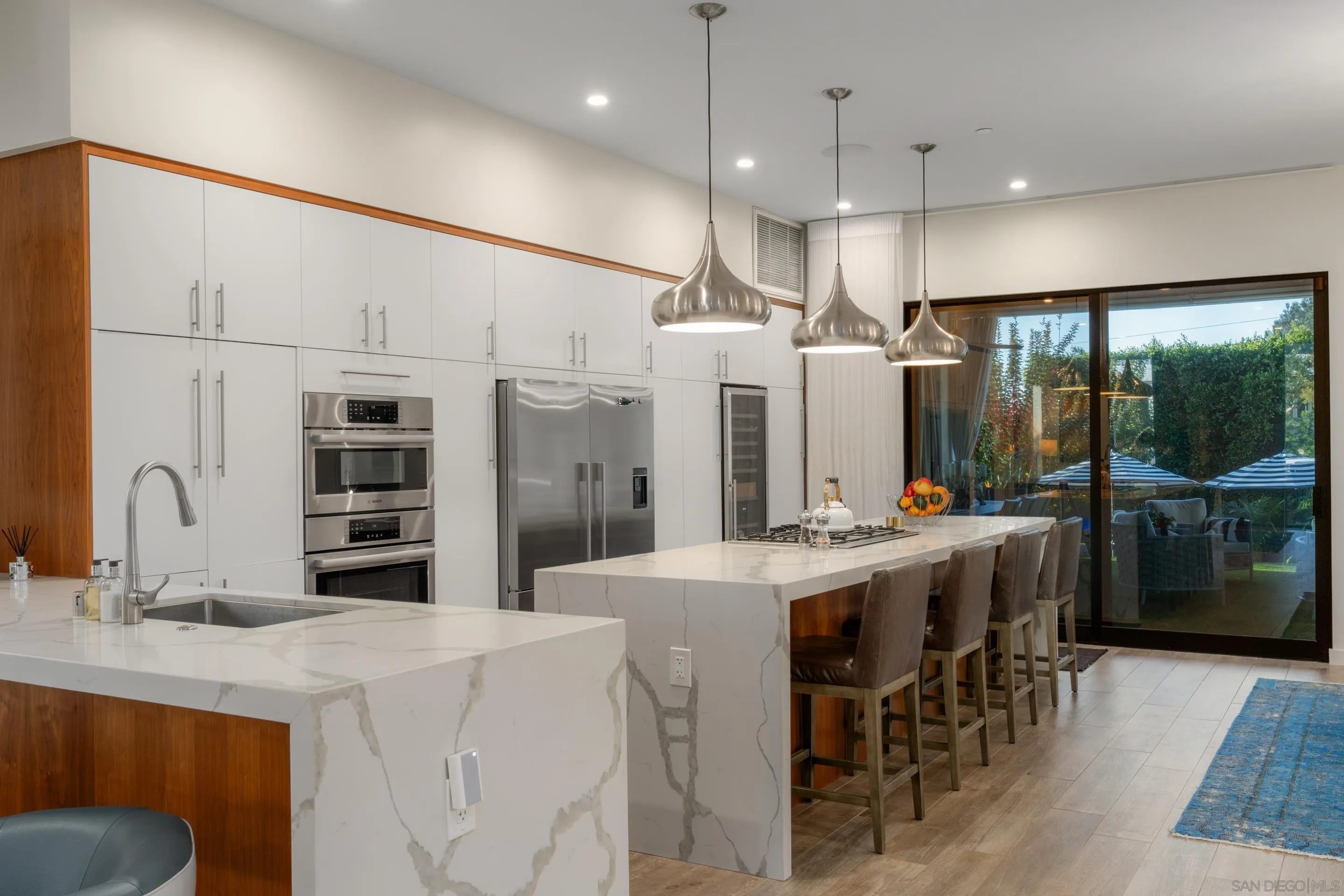 1224 Virginia Way La Jolla, CA 92037 - Photo 6 of 45 a kitchen with kitchen island a large counter top space appliances and cabinets