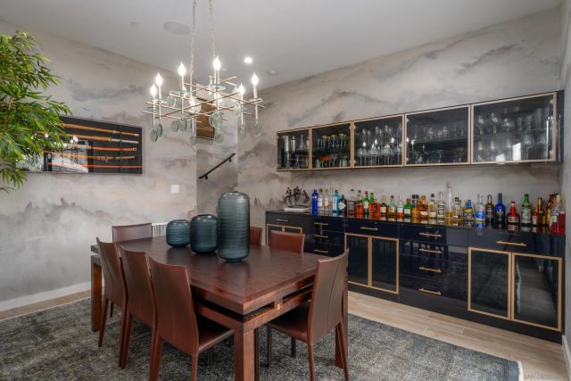 a view of a dining room with furniture and chandelier