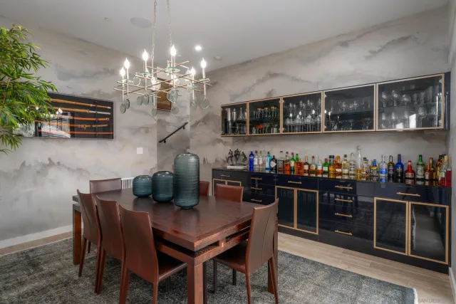 a view of a dining room with furniture and chandelier