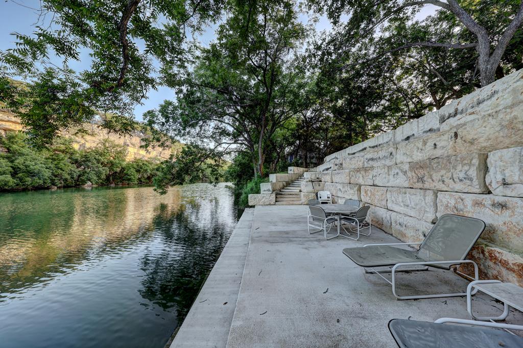 157 Cedar Cliff Loop West Hunt, TX 78024 - Photo 6 of 35 a view of a lake with outdoor seating and plants