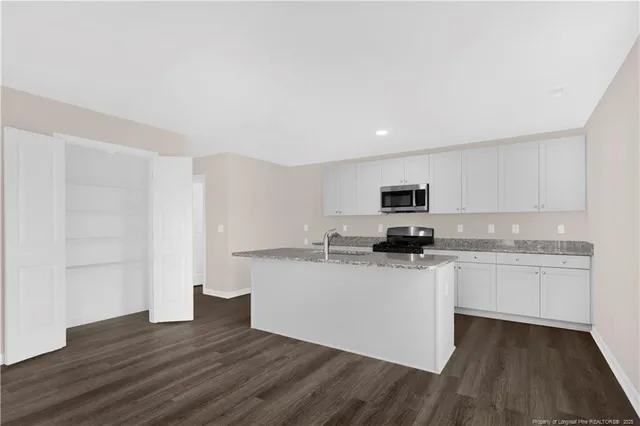 a kitchen with stainless steel appliances granite countertop a sink and cabinets