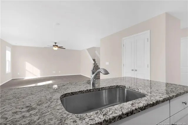 a kitchen with a sink and vanity