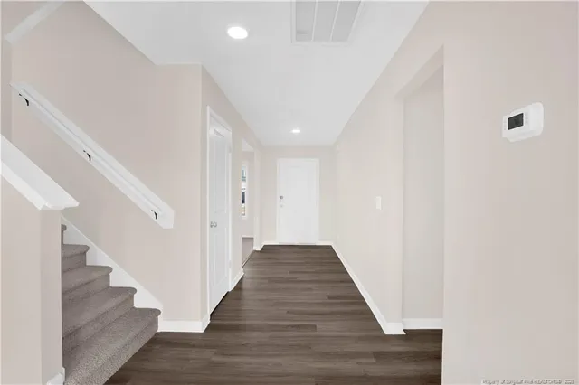 a view of a hallway with wooden floor