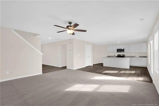 a view of a kitchen with a sink and refrigerator