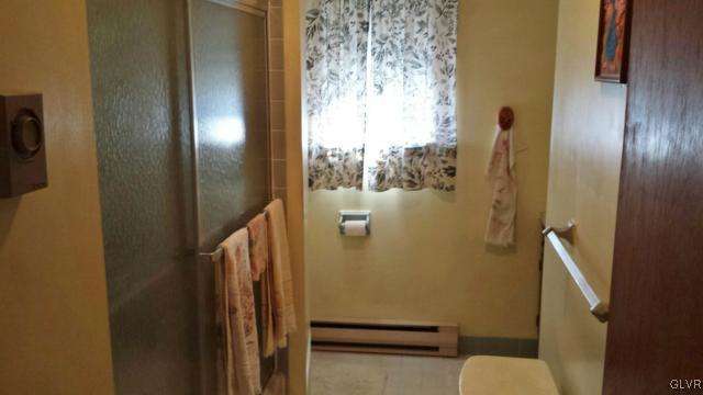 117 Hoffman Road Wind Gap, PA 18091 - Photo 12 of 15 a bathroom with a toilet and a shower curtain