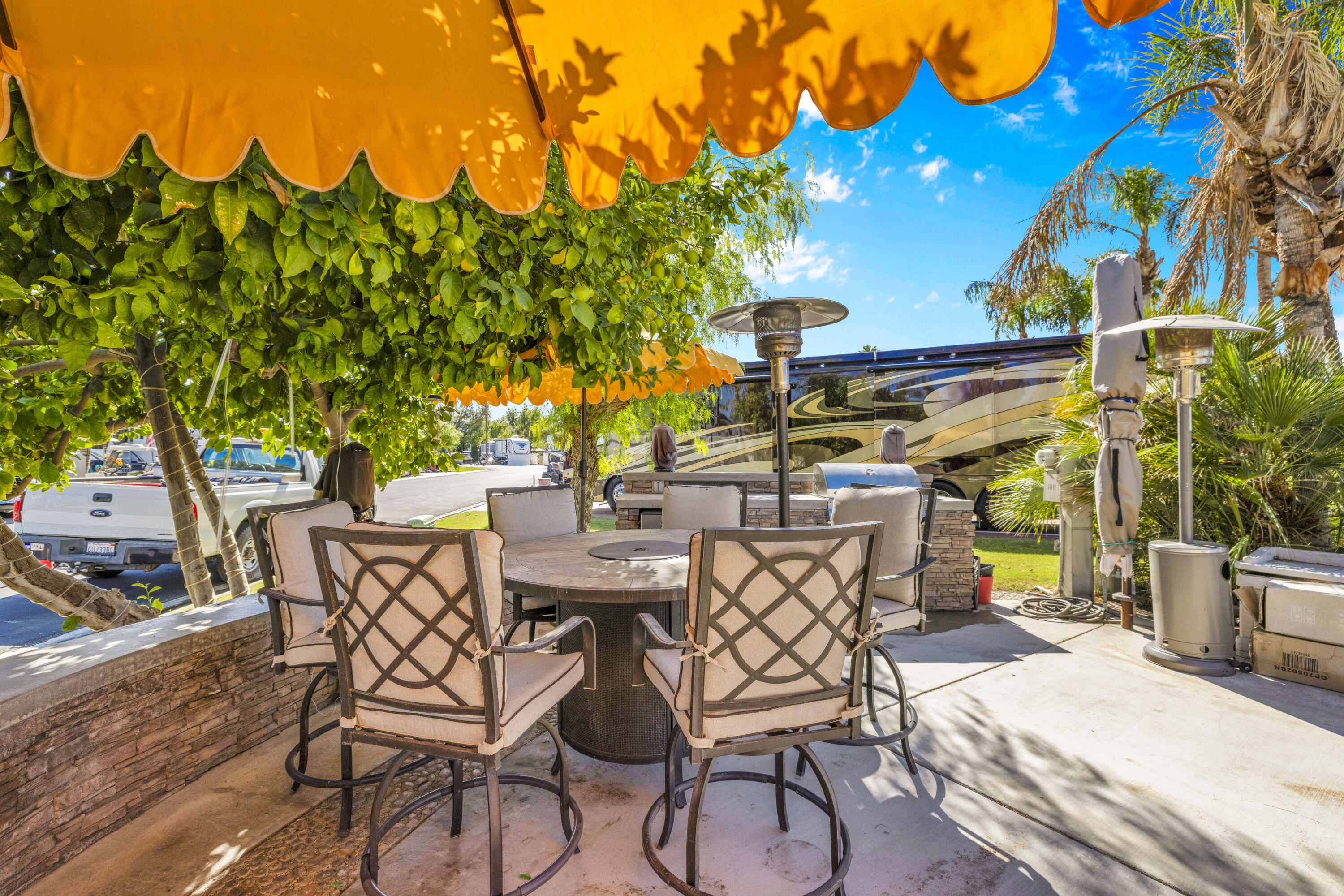 69411 Ramon Road, Unit 1011 Cathedral City, CA 92234 - Photo 5 of 46 a view of a patio with table and chairs and potted plants