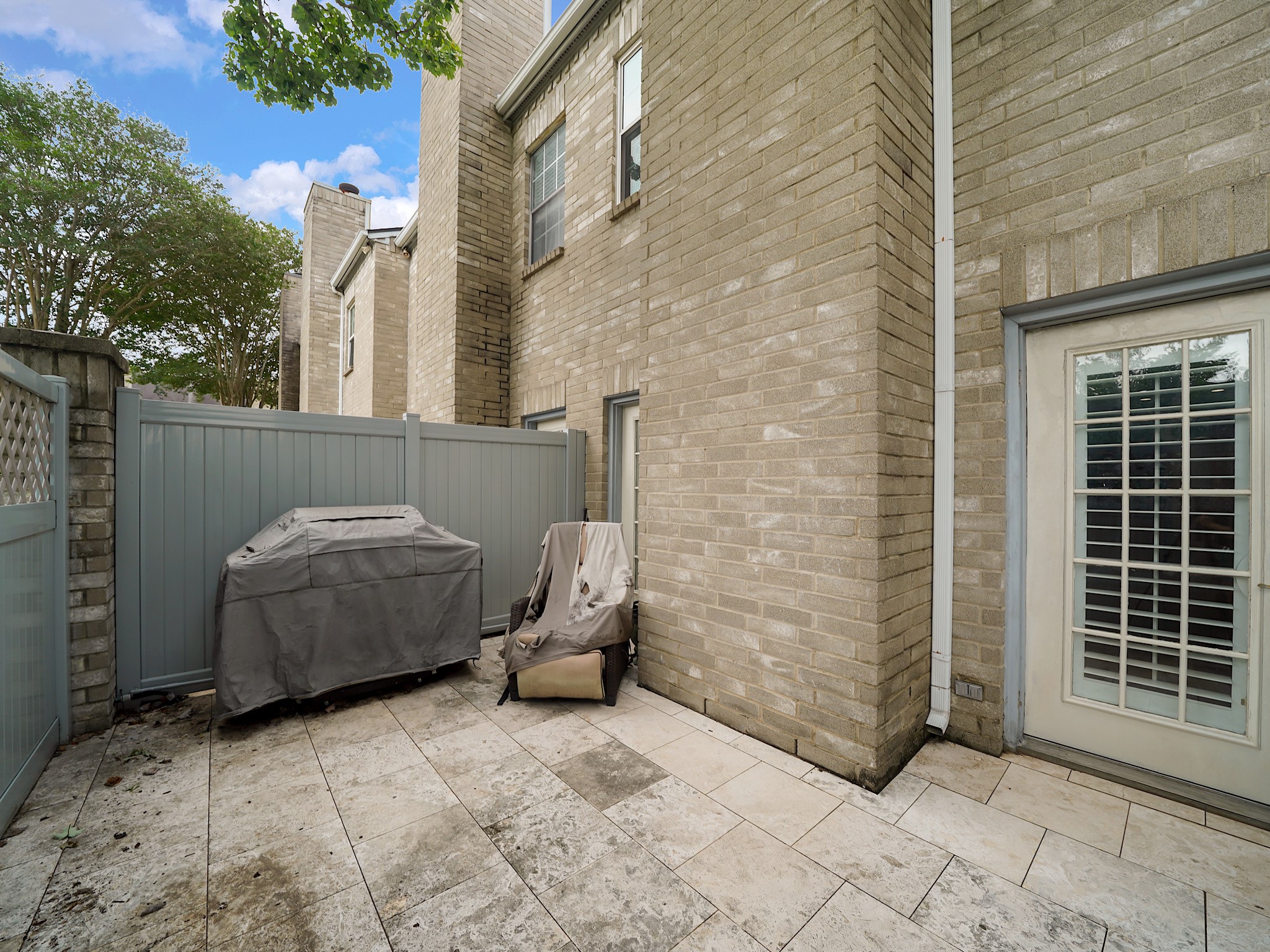 6000 Reims Road, Unit 2205 Houston, TX 77036 - Photo 29 of 35 Secluded back patio offering outdoor living space. The grill is included with the home.