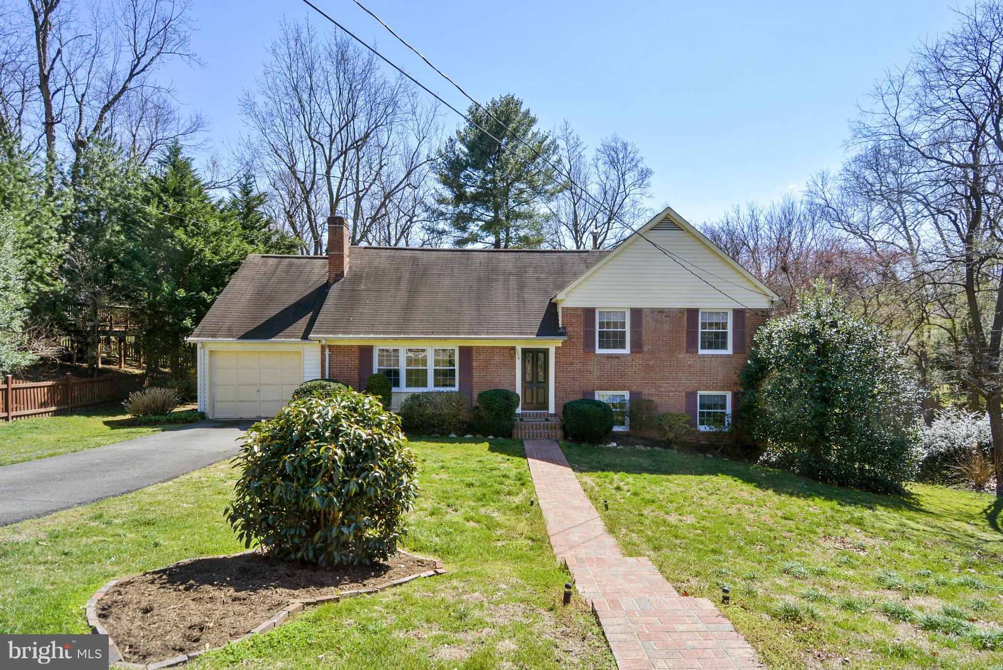 1954 Foxhall Road McLean, VA 22101 - Photo 1 of 30 a view of a yard in front of a house with large windows