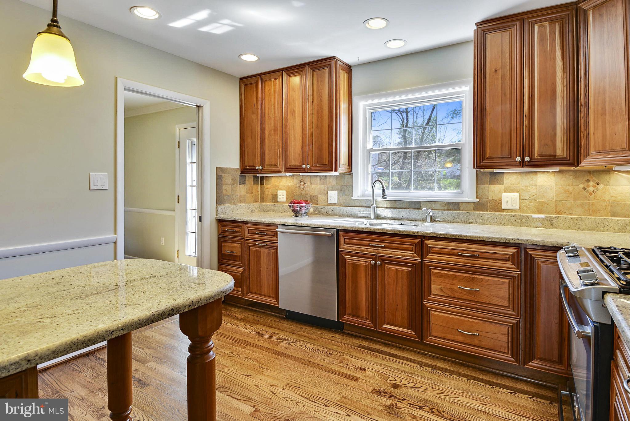 1954 Foxhall Road McLean, VA 22101 - Photo 8 of 30 a kitchen with stainless steel appliances granite countertop wooden cabinets a sink and dishwasher