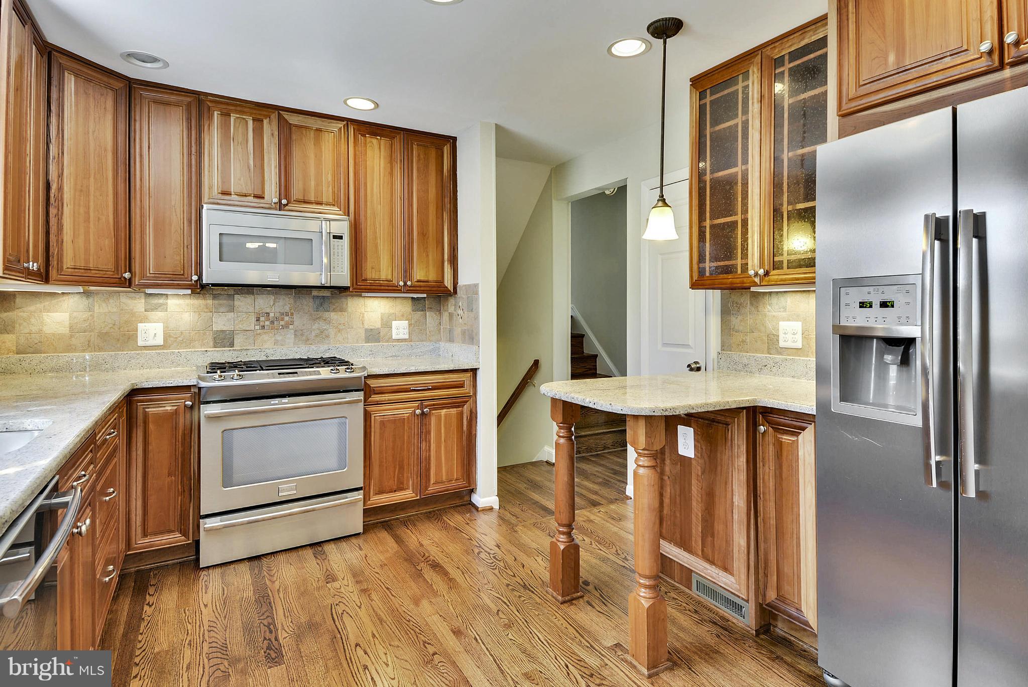 1954 Foxhall Road McLean, VA 22101 - Photo 9 of 30 a kitchen with stainless steel appliances granite countertop a stove a sink and a refrigerator
