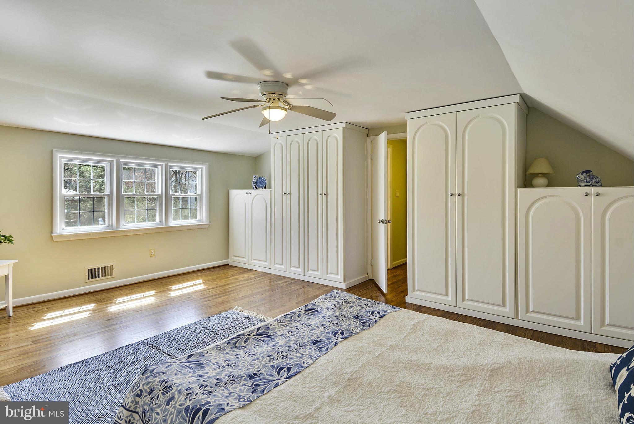 1954 Foxhall Road McLean, VA 22101 - Photo 10 of 30 a view of a livingroom with wooden floor a ceiling fan and windows