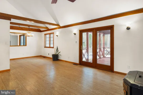 a view of an empty room with window and cabinet