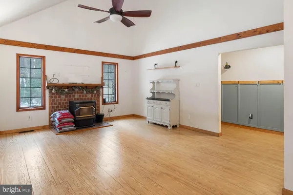 an empty room with a fireplace and wooden floor