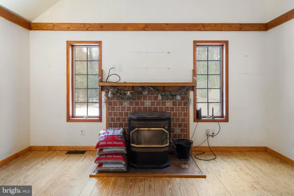a view of a room with wooden floor and a window