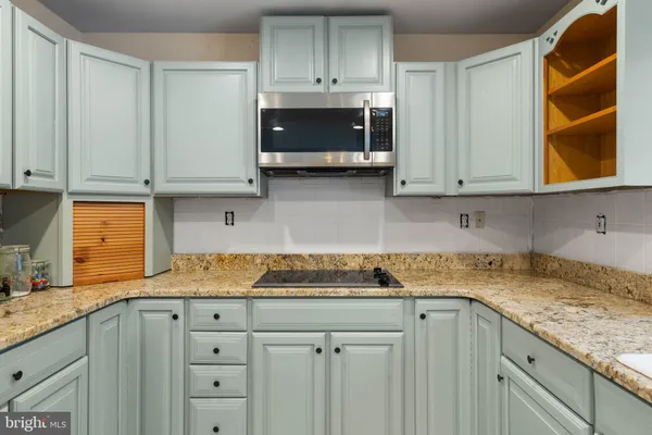 a kitchen with refrigerator and cabinets