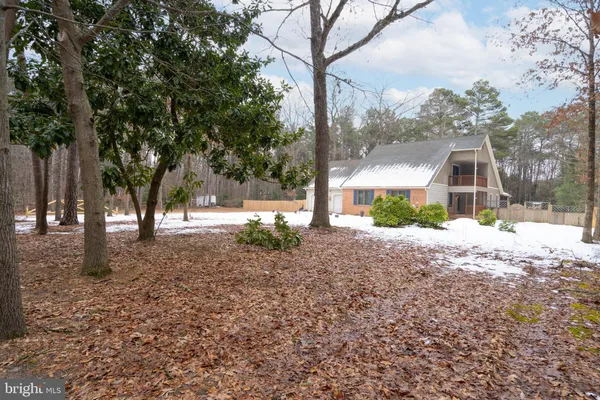 a view of a yard with snow on the road