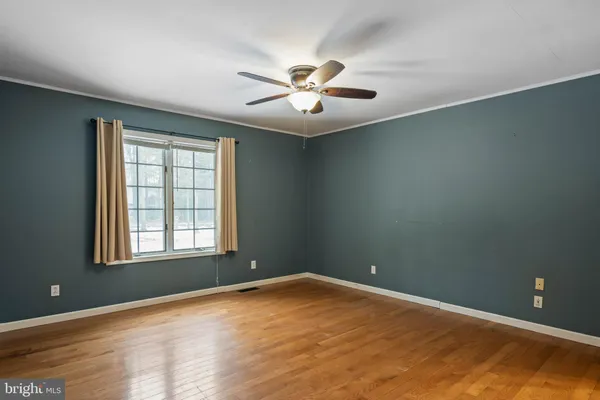a view of room with window and ceiling fan