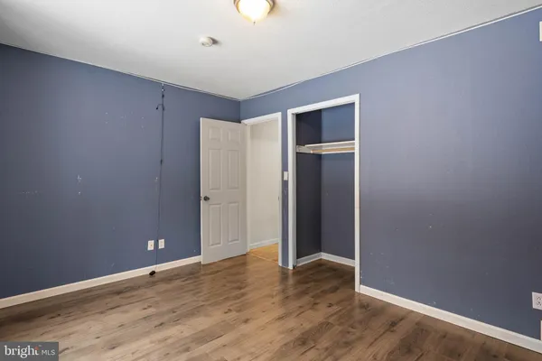 a room with a dresser and a window