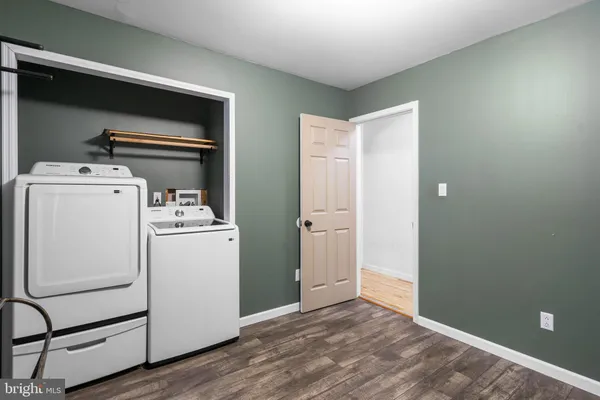 a bathroom with a granite countertop toilet sink and mirror