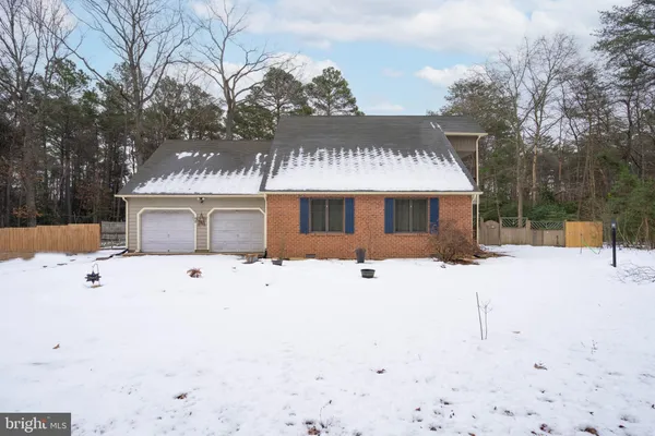 a white house with a large tree in front of it