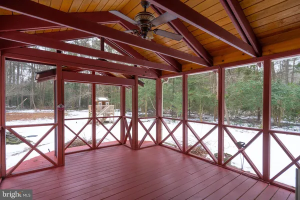 a view of an empty room with a fireplace and a window