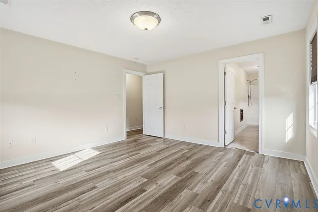 a view of an empty room and wooden floor