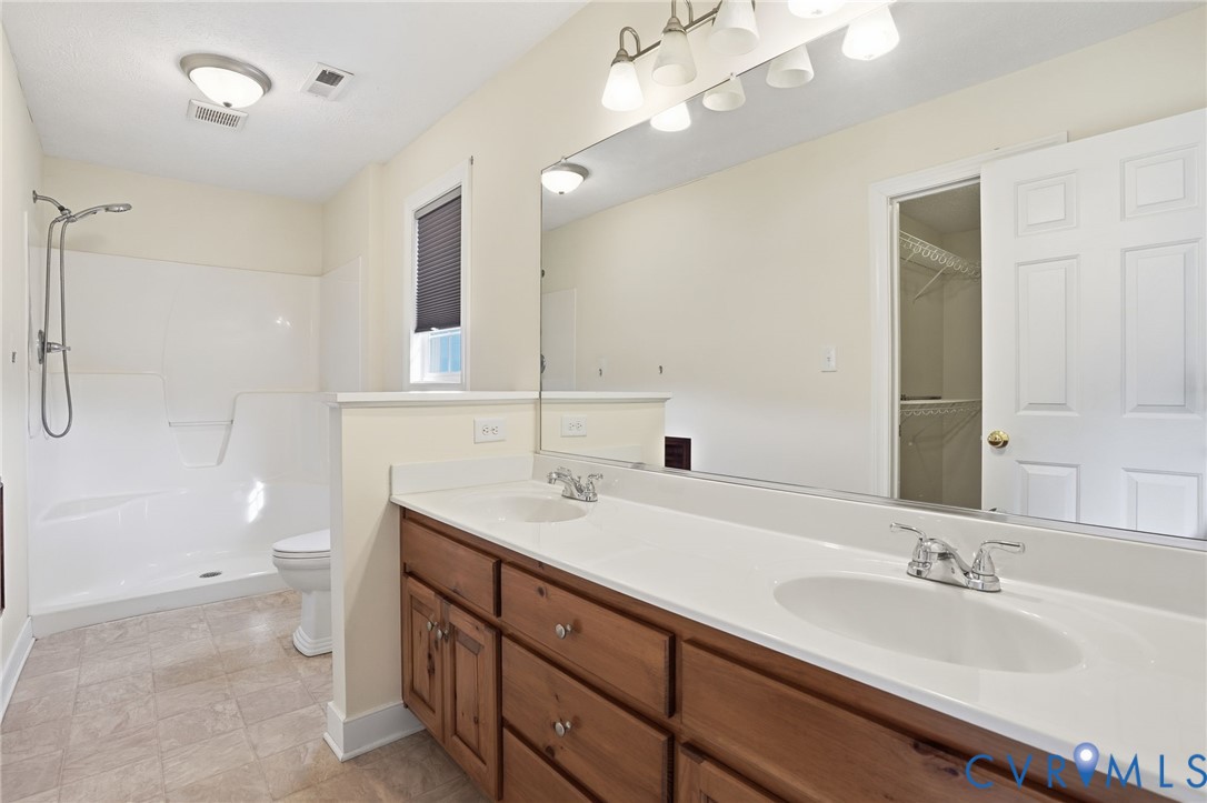 1220 Walkerton Road Walkerton, VA 23177 - Photo 17 of 33 a bathroom with a sink double vanity granite and a toilet