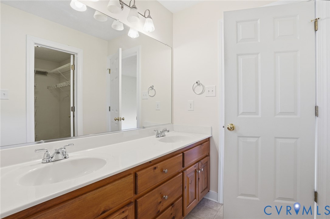 1220 Walkerton Road Walkerton, VA 23177 - Photo 18 of 33 a bathroom with a double vanity sink and a mirror
