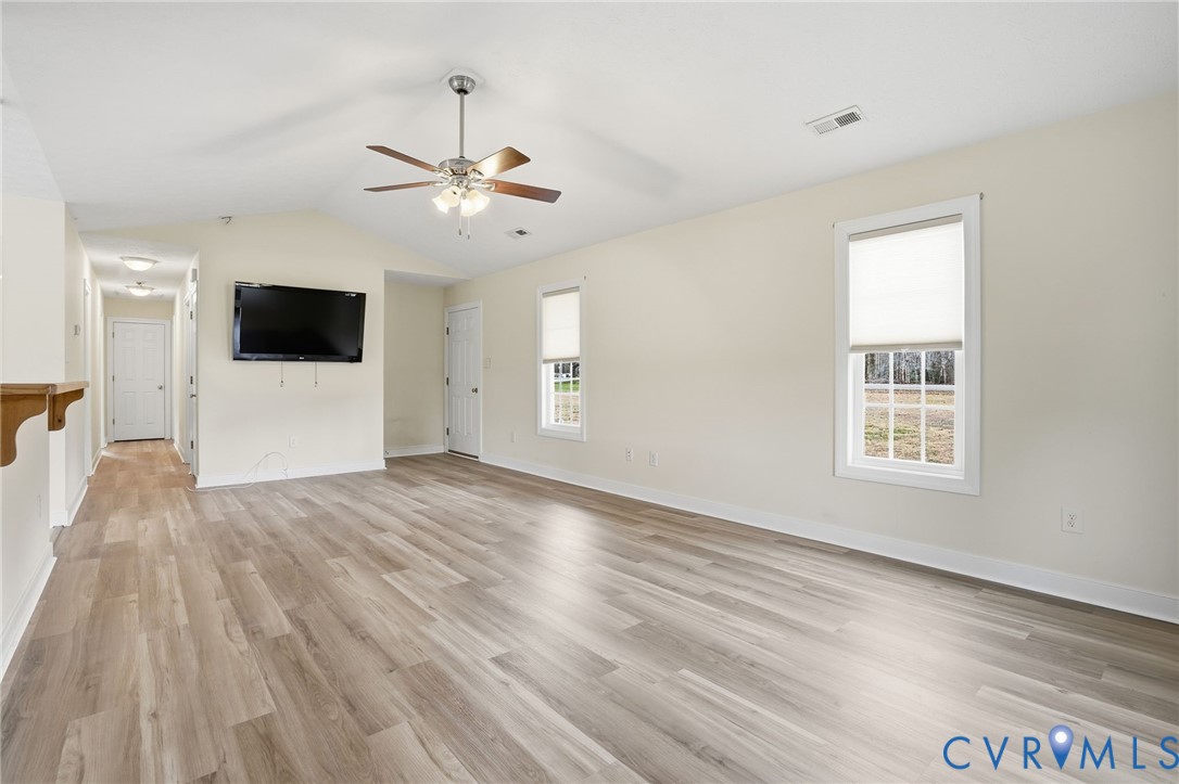 1220 Walkerton Road Walkerton, VA 23177 - Photo 8 of 33 a view of an empty room with a window and wooden floor