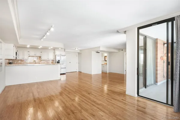 a view of an empty room and wooden floor