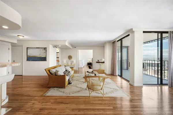 a living room with fireplace furniture and a wooden floor