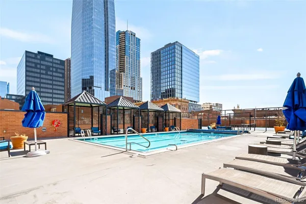 a small garden with tall buildings in the background