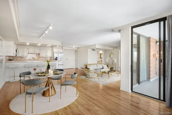 a living room with lots of furniture and kitchen view