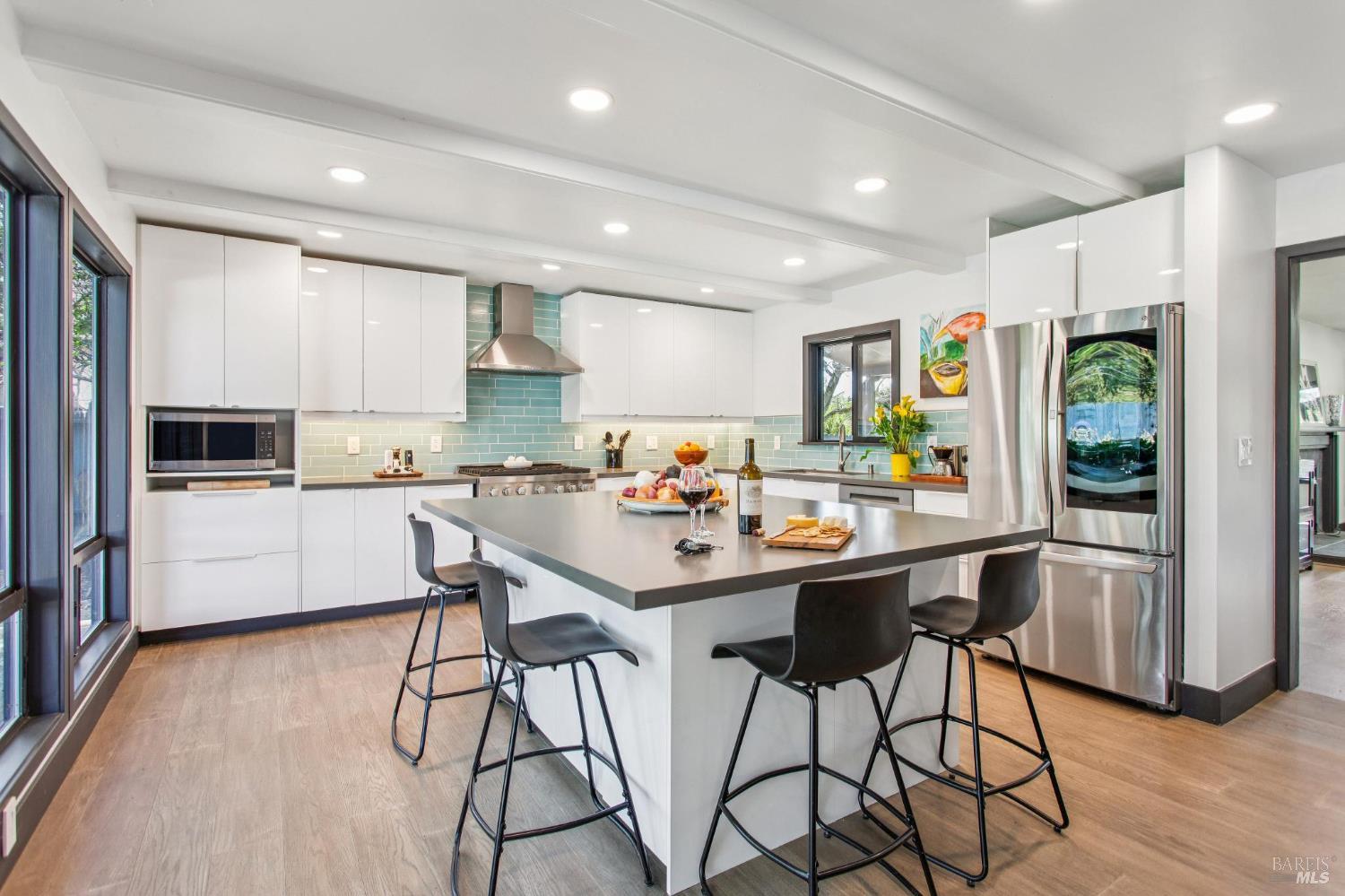 Incredible kitchen with an abundance of couter space and storage.  6 burner gas range.  Island  6.8 ft. X 5 ft. Lots of windows with views of the gardens and pool area.