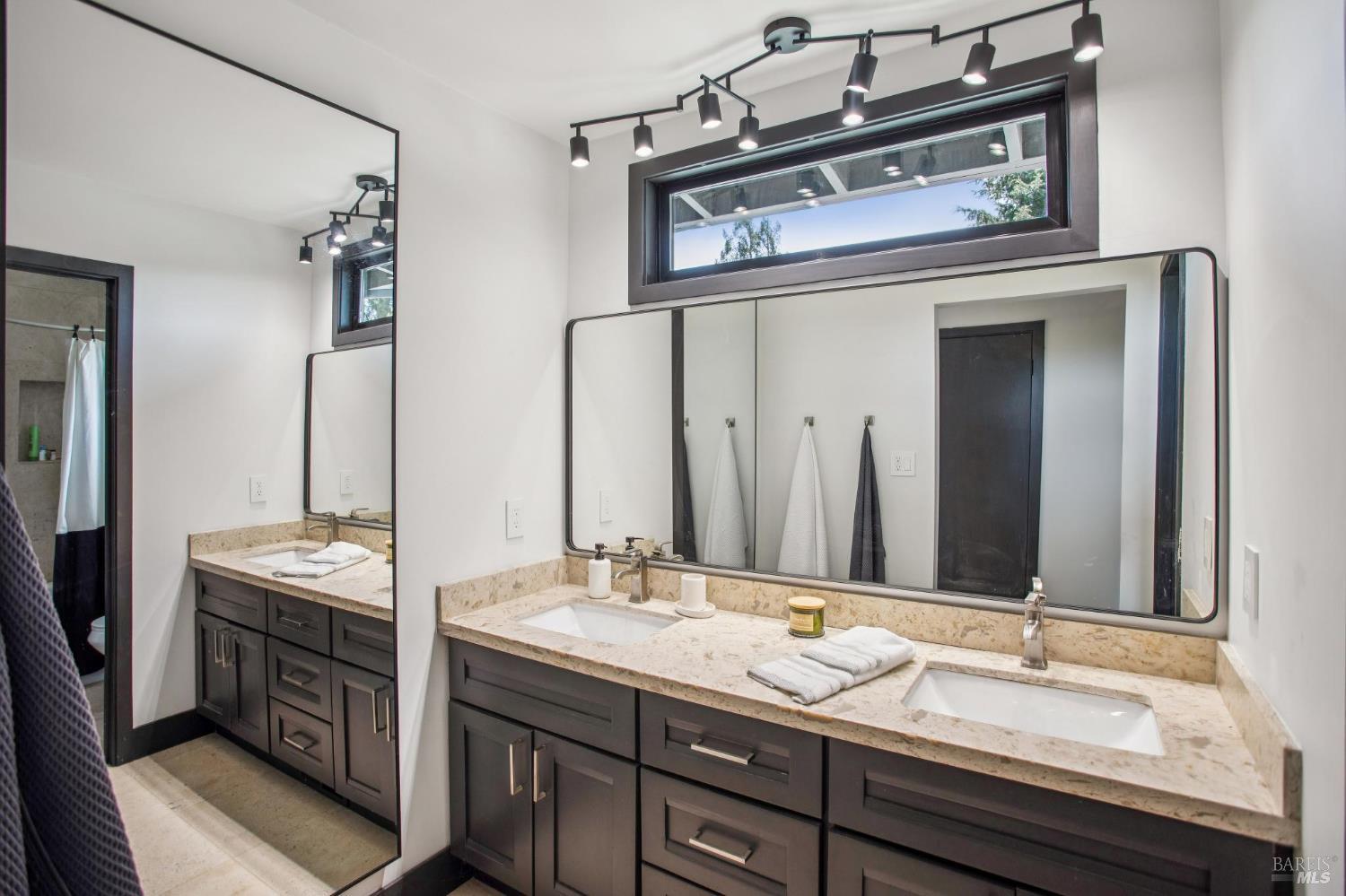 2100 Center Road Novato, CA 94947 - Photo 13 of 32 The upstairs has two bedrooms or a primary suite with roof top deck. This space has views of the back pool area.